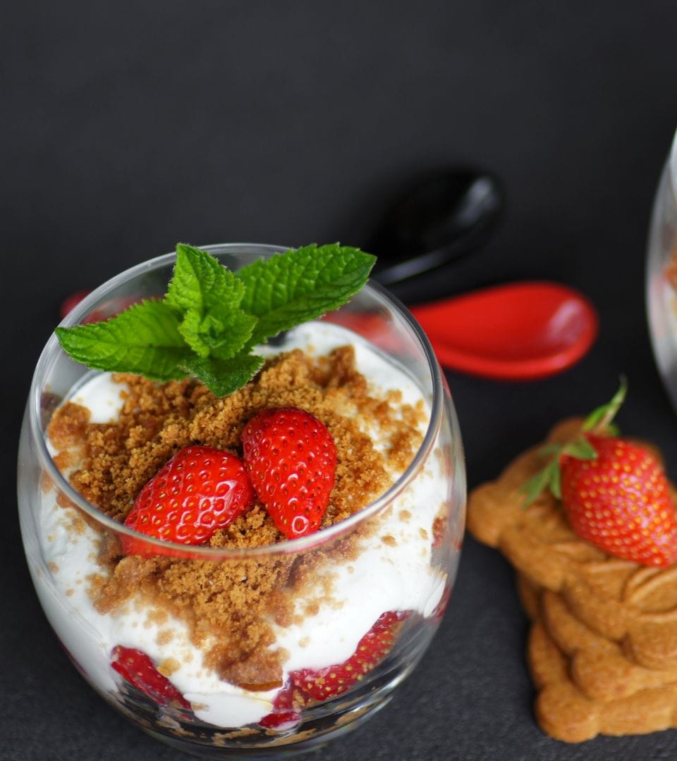 delicious strawberry yoghurt in a glass with whole strawberries