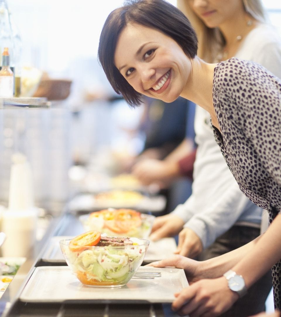 woman getting food from delegate contract catering service