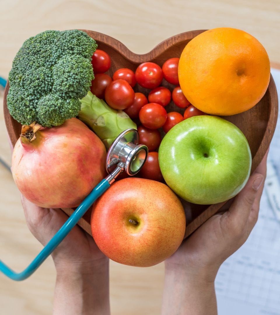 various fruits, vegetables arranged in a heart shape